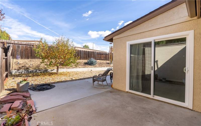 Immediately adjacent to the sliding glass and garage doors, is a nice ~10'x 10' concrete patio just waiting for you to set up a barbecue!