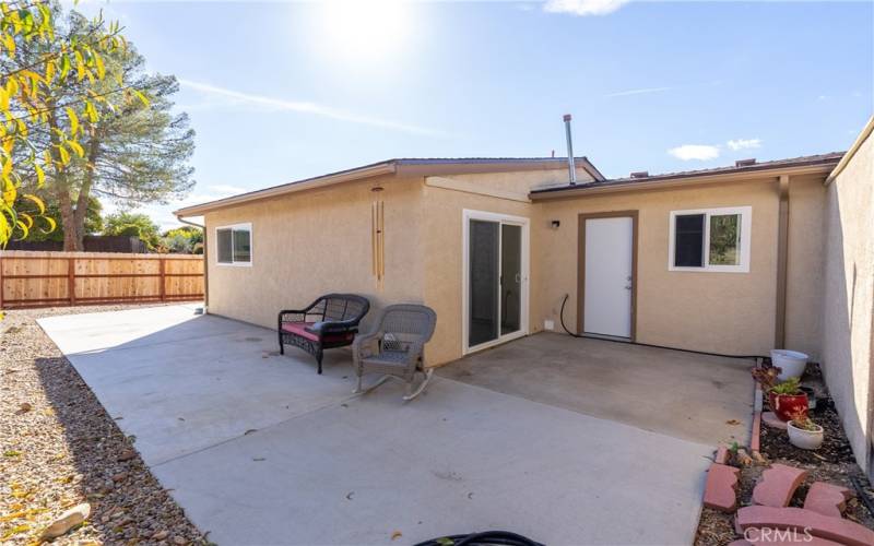 Hardscape abounds! There is a terrific maintenance-free concrete pad that anchors the side and back of the home.