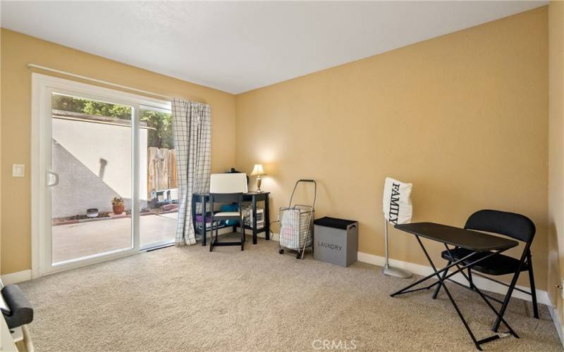 Bedroom 2 is a large, carpeted room with a new dual-paned sliding gas door to the patio.