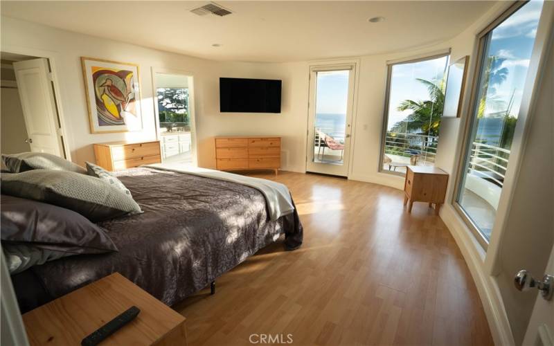 Primary ensuite bedroom (2nd Level) with deck and panoramic ocean views.