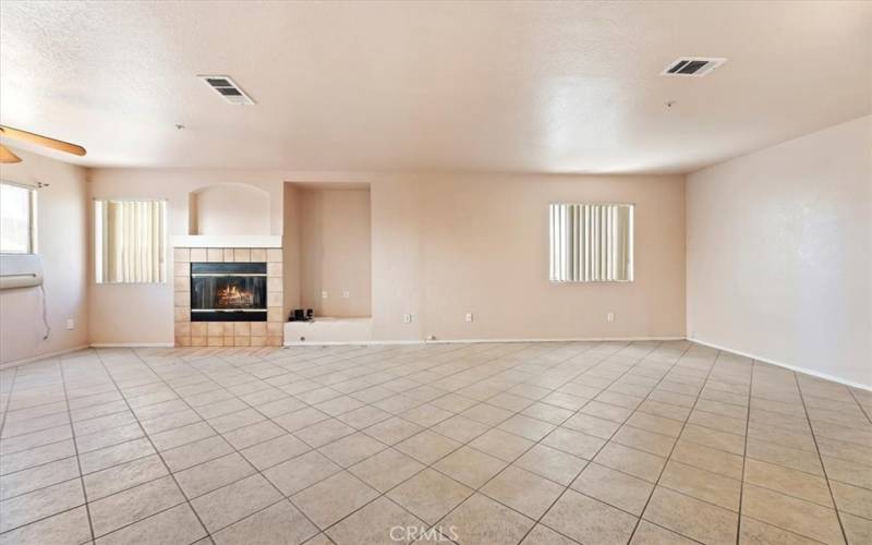 Family room with fireplace and door to backyard.