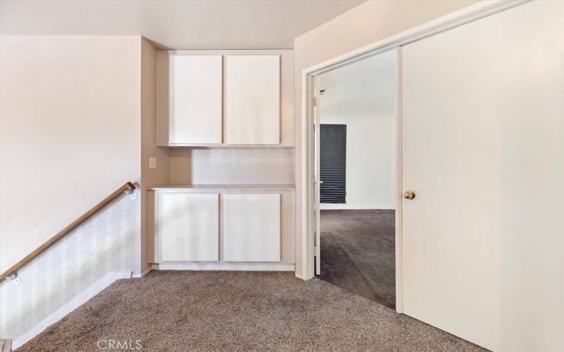 This linen closet is a great place to store linens and other items. It's located in the hallway, which makes it convenient to store items you need for the bedroom.