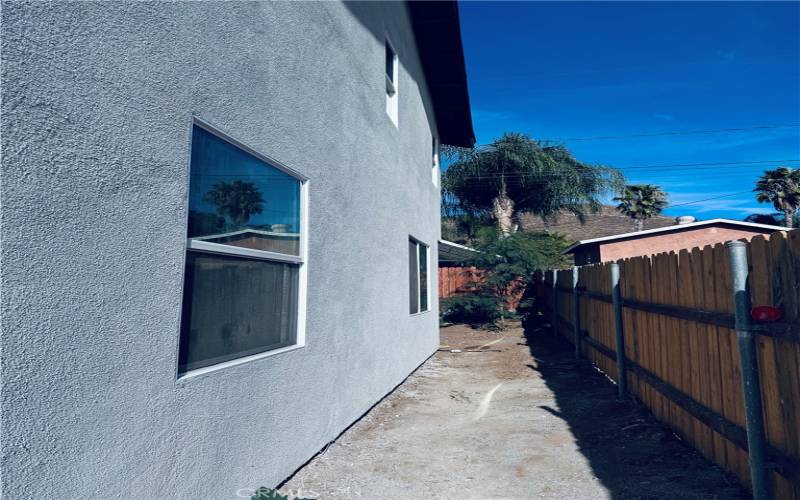 SIDE OF THE PROPERTY WITH WOOD FENCING