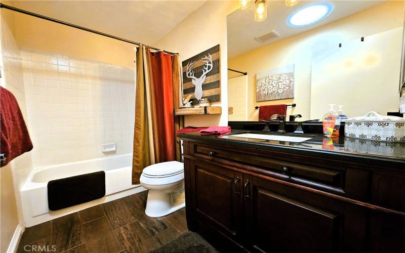 hall bath, tub and tile, new floor, new vanity