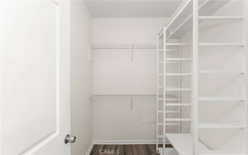 and a spacious walk-in closet with organizers