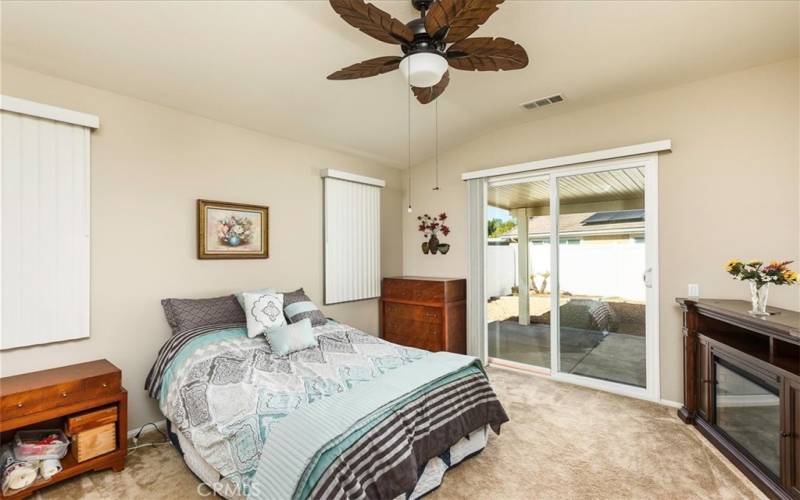 Primary bedroom with sliding door out to wonderful back yard.