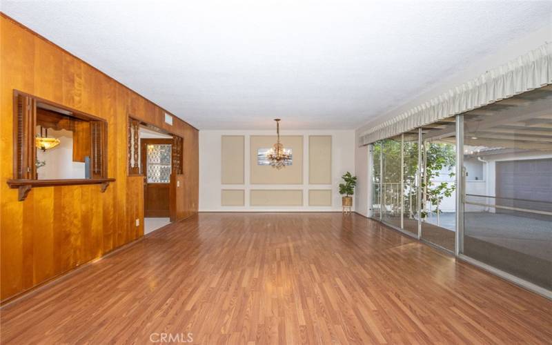 Living Room and Dining Room with view of Kitchen and Direct Backyard Access