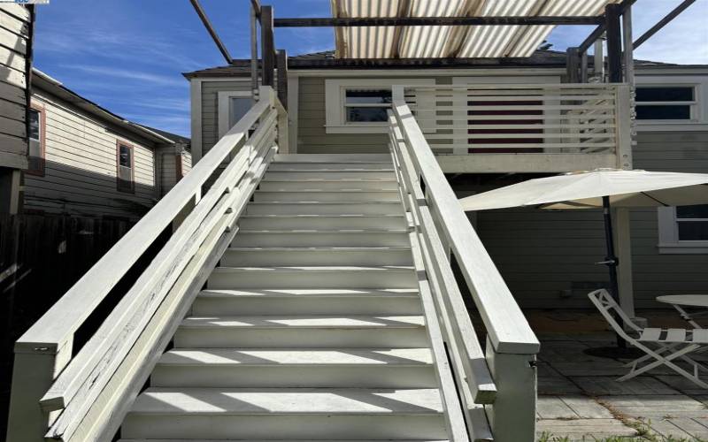 Sturdy back stairs provide easy access to the spacious back yard