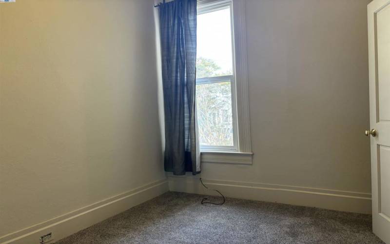 Bright upstairs bedroom features new carpet and fresh paint.