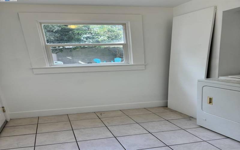 Bright Laundry Room includes full size washer and dryer