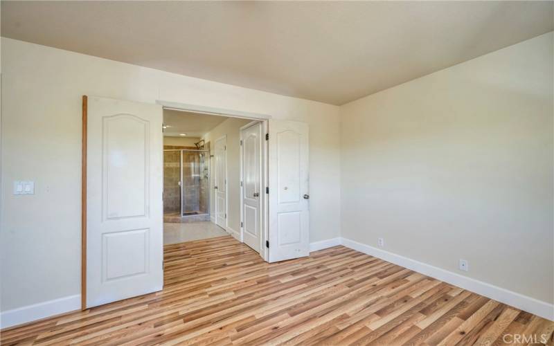 Primary suite with french doors leading into bath