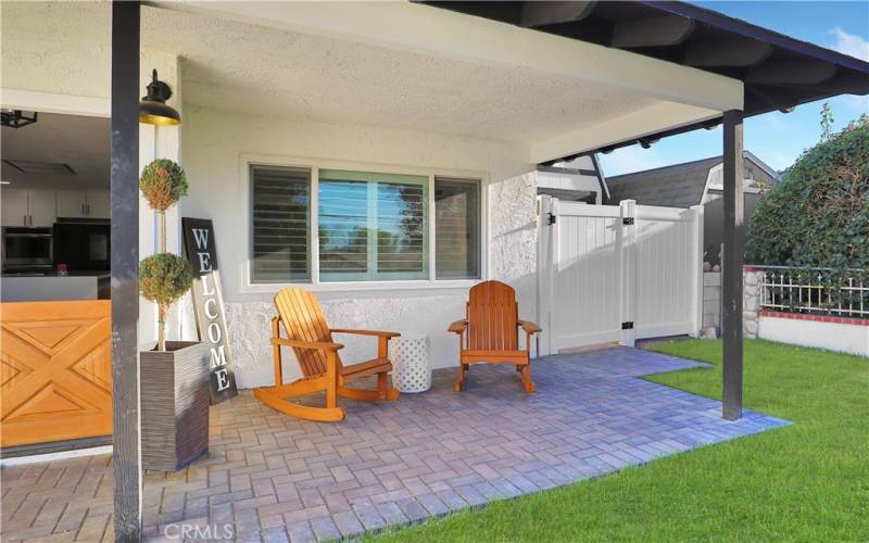 Welcoming, covered front porch with pavers