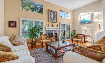 Living room w/ soating high ceiling, Wood floors, FPLC