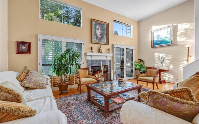 Living room w/ soating high ceiling, Wood floors, FPLC