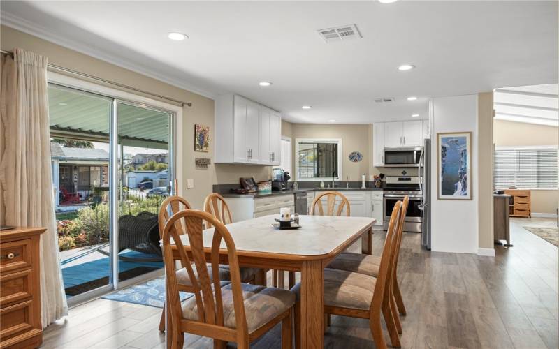 Kitchen opens to dining room with view of the canal.