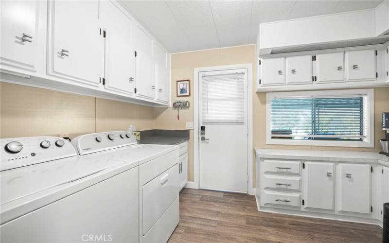 Large laundry room w. new washer and dryer and tons of storage.