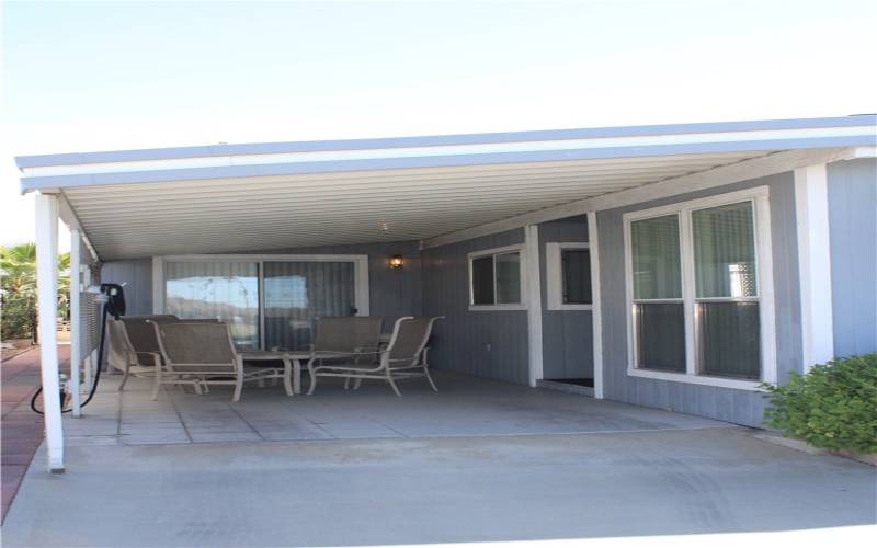 Side patio w/golf course view & extra parking.