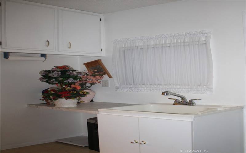 Laundry room utility sink  & desk/folding area.