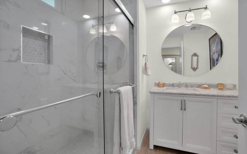 Beautiful shower with marble mosaic tile niche and floor