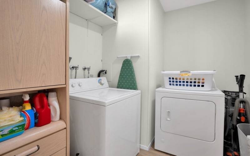 Huge laundry room with tons of storage! There's even room to add more cabinets above the dryer if you want!