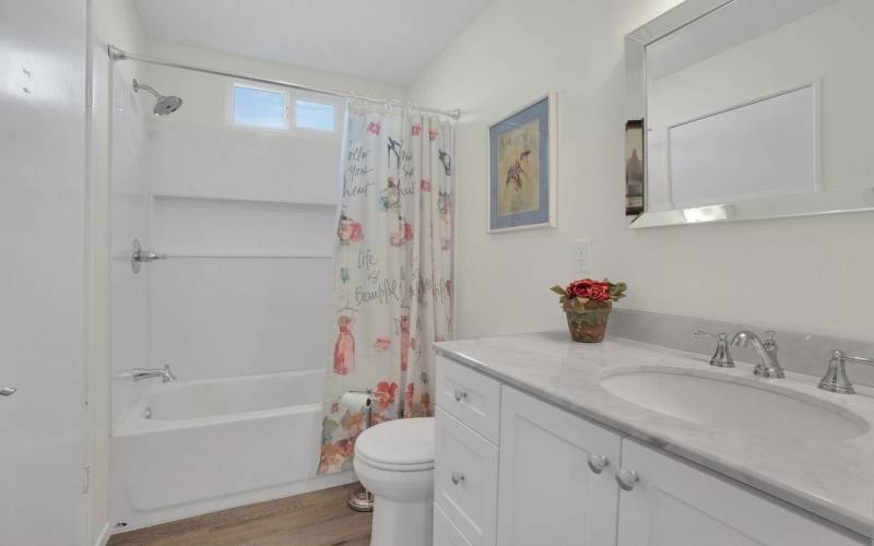 This is the second bath with new vanity, shower over tub and there's a linen closet in here too!