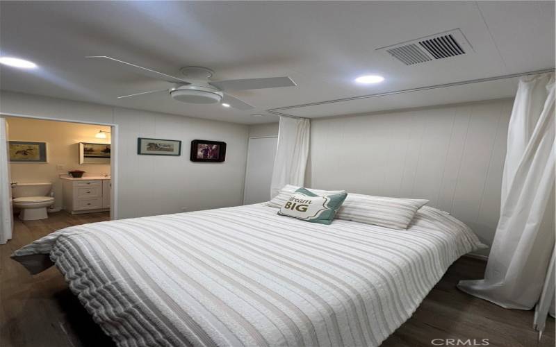 View of murphy bed and adjoining bathroom in the distance