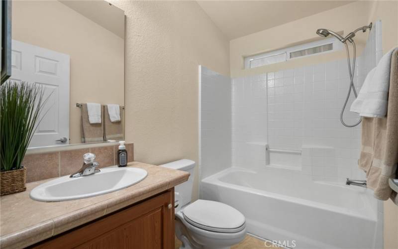 Secondary bath with tub and shower combo.