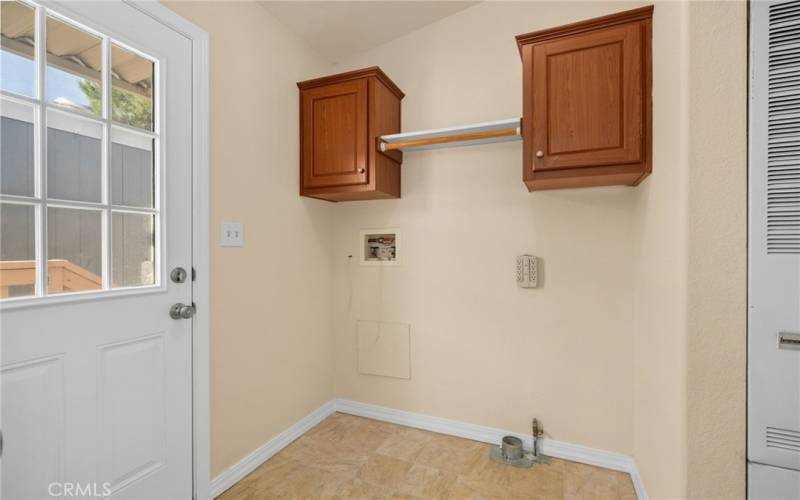 Kitchen with cabinetry and outside access door.