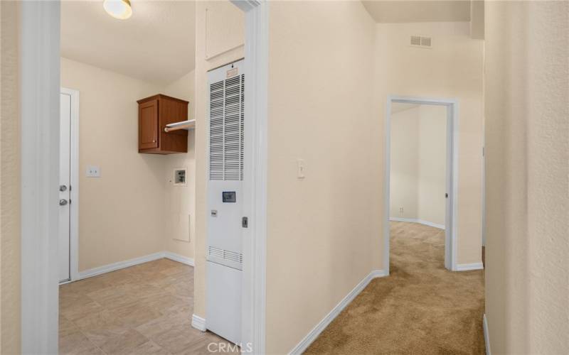 Large laundry room that can be closed off with doors but is accessible from both the kitchen and hallway.