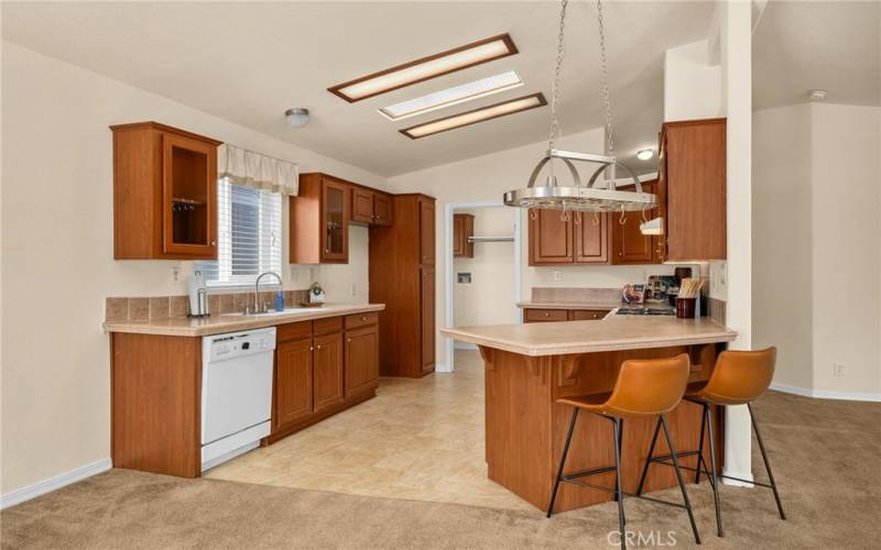 Great kitchen with pot rack and breakfast bar.