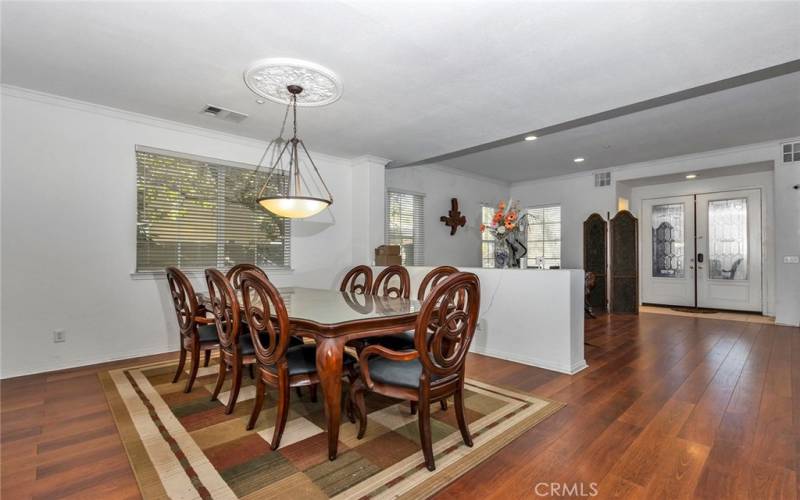 Dining room, living room, and entryway with double doors.