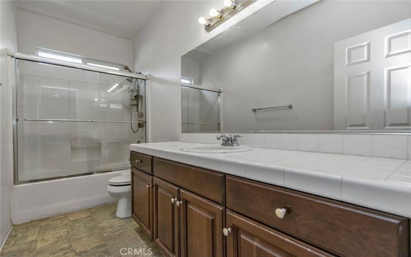 Upstairs guest bath #1 with shower in tub.