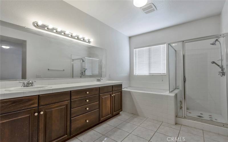 Primary bath with dual sinks, separate tub and walk-in shower