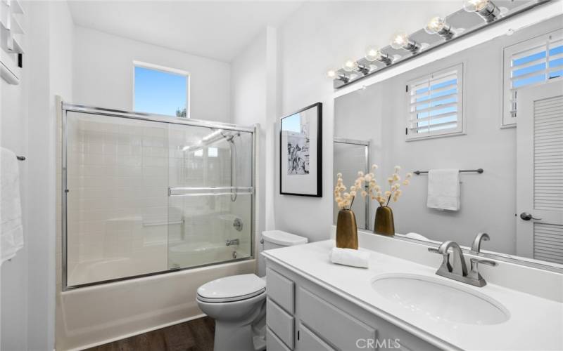 Second bathroom w/ multiple windows, offering cheerful sunlight