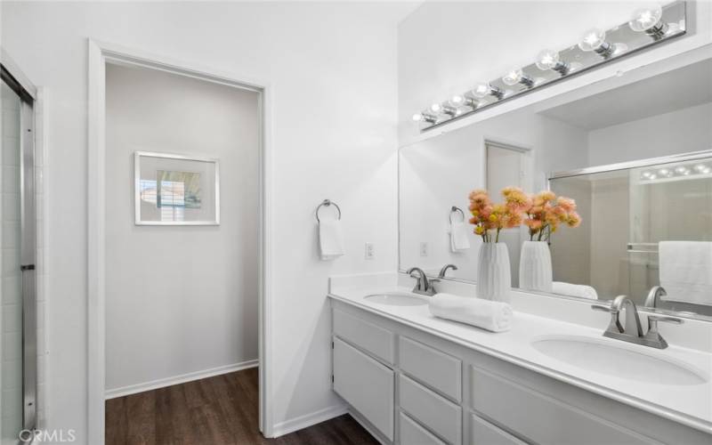 En-suite offers dual vanities, upgraded flooring & privacy door