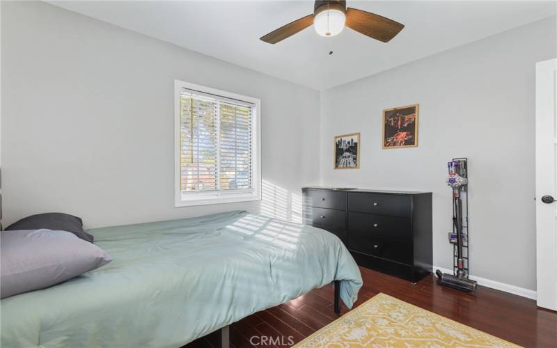 2nd Bedroom showing off the gleaming hard wood floors.