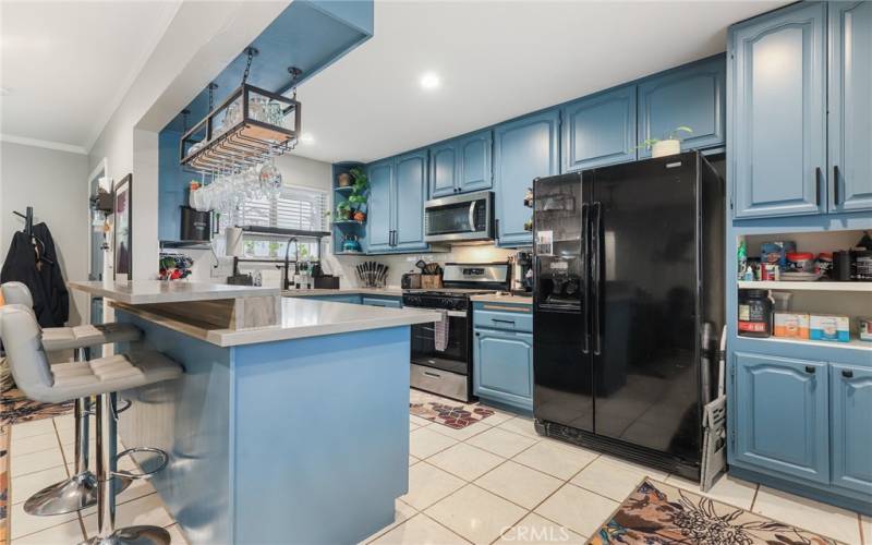 Kitchen has been tastefully remodeled with Cesar Stone counter tops, shaker custom cabinetry and extended bar area for another gathering spot