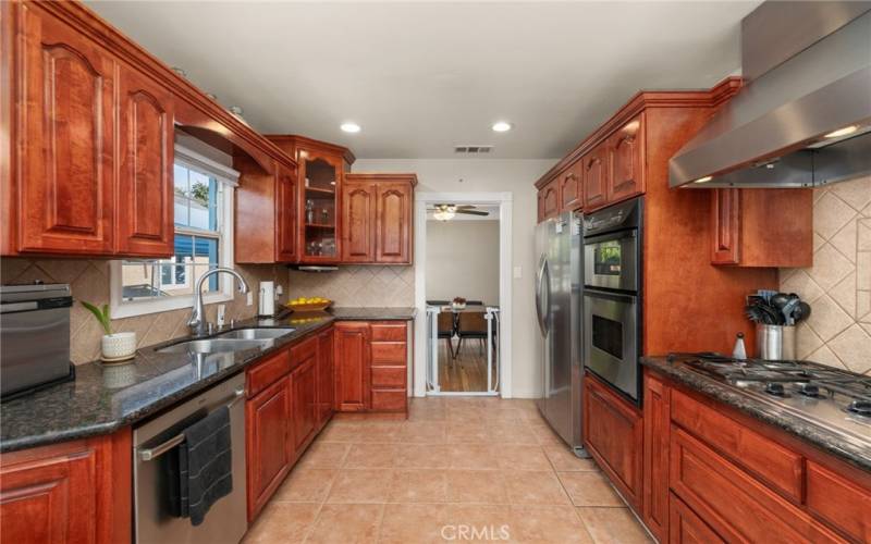 Updated kitchen complete with stainless steel appliances, granite countertops, and plenty of cabinet space.