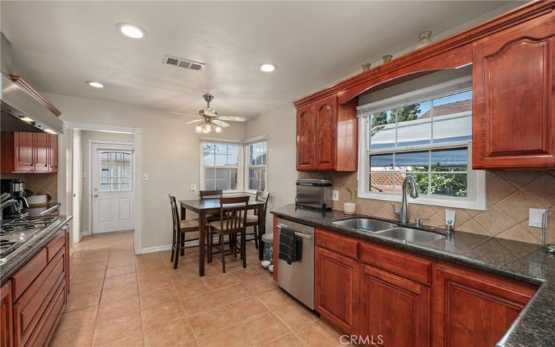 Kitchen features recessed lighting and room for an eating area.