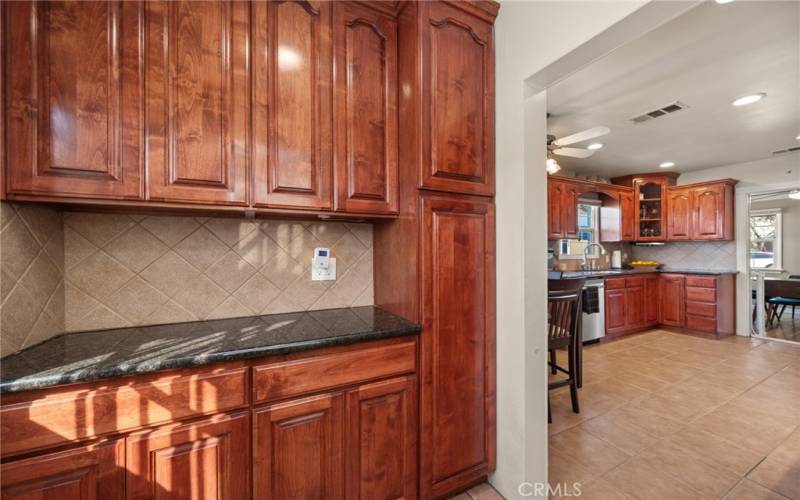 Custom cabinets perfect for pantry storage and your coffee and tea bar.  Half bath also in this foyer pantry area.