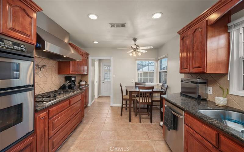 View of kitchen looking into pantry and door for backyard access.