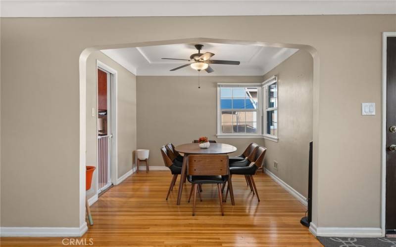 Dining room area with gorgeous entry and plenty of windows to bring in natural lighting.