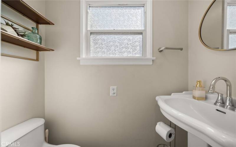 Half bath located off the pantry and kitchen area.