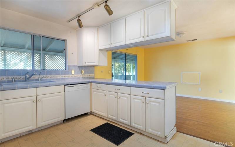 Kitchen & dining area with sliding glass door out to covered deck.