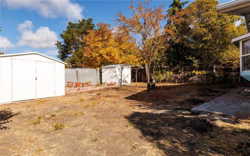 Large backyard with two sheds included.