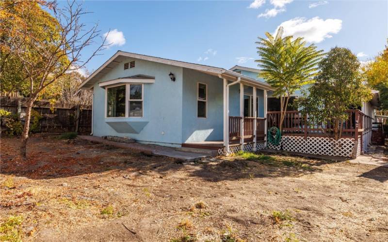 Spacious backyard with bay window and wrap around deck.