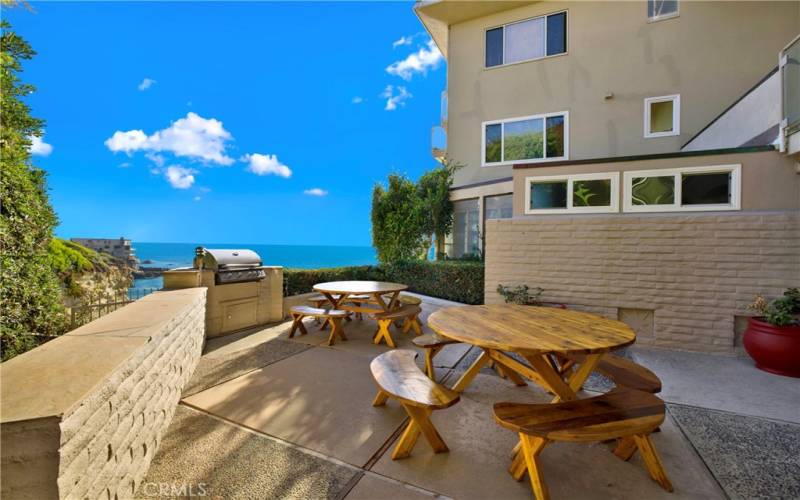 Outdoor BBQ area with seating just below the unit includes seating and ocean views beyond!