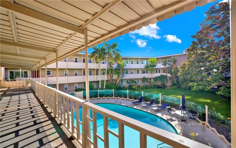 Balcony of laundry, recreation room & gym looking down towards pool area.