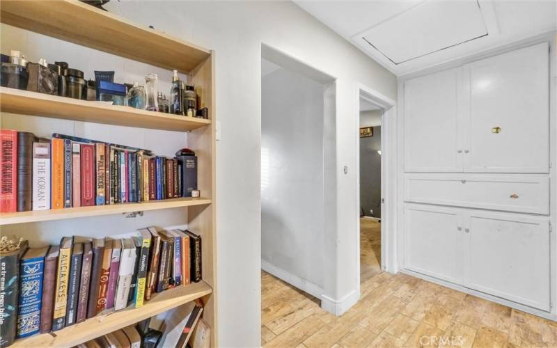 Hallway with linen cabinets offering plenty of storage.