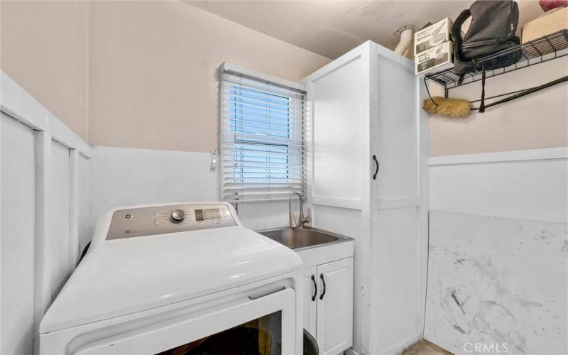 Laundry room off the kitchen offers plenty of storage.